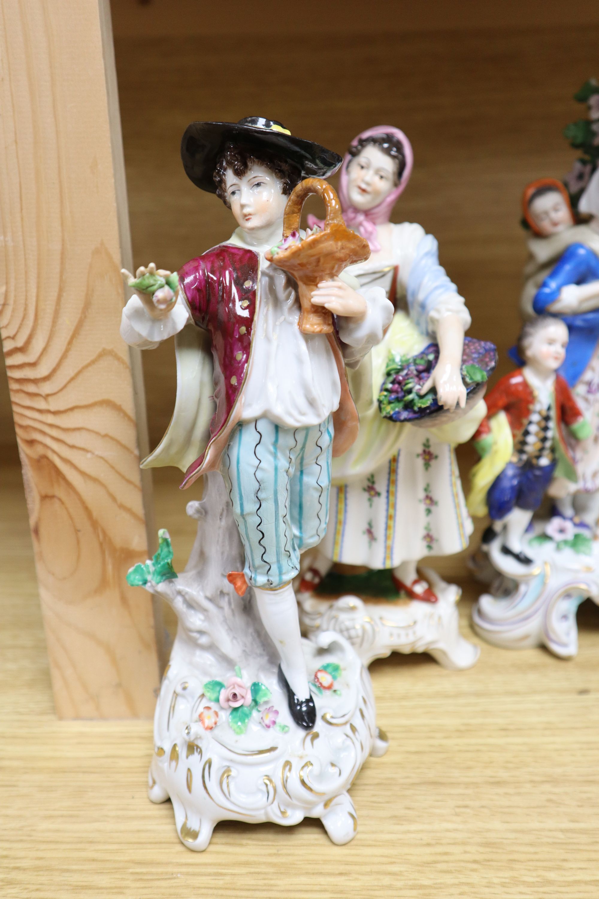 A Hochst porcelain shepherd and shepherdess group and four other modern Continental figures